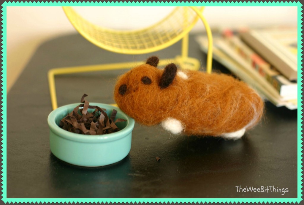 Image of handmade wool felt hamster eating out of pretend food bowl