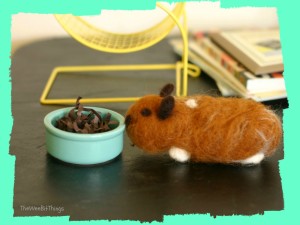 Image of a wool felt hamster approaching his food bowl